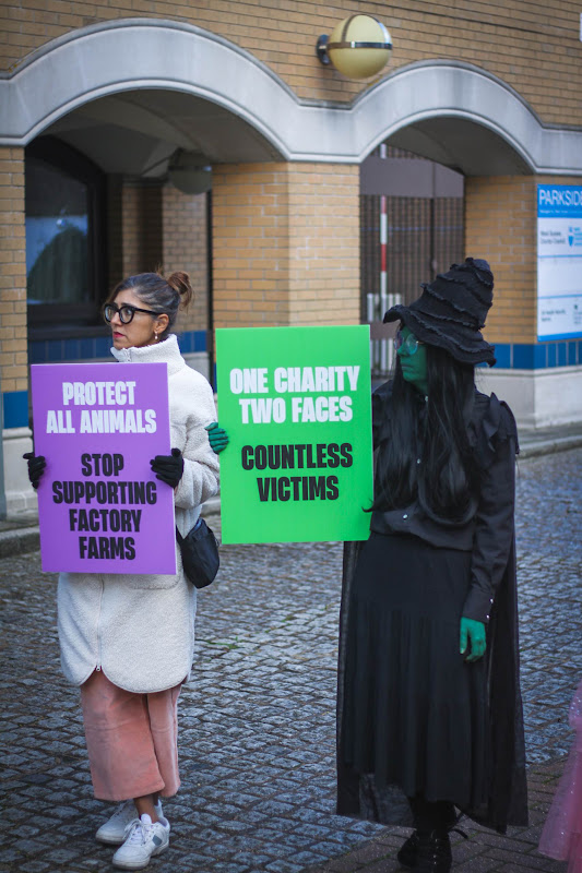 Protestors holding placards: Drop RSPCA Assured