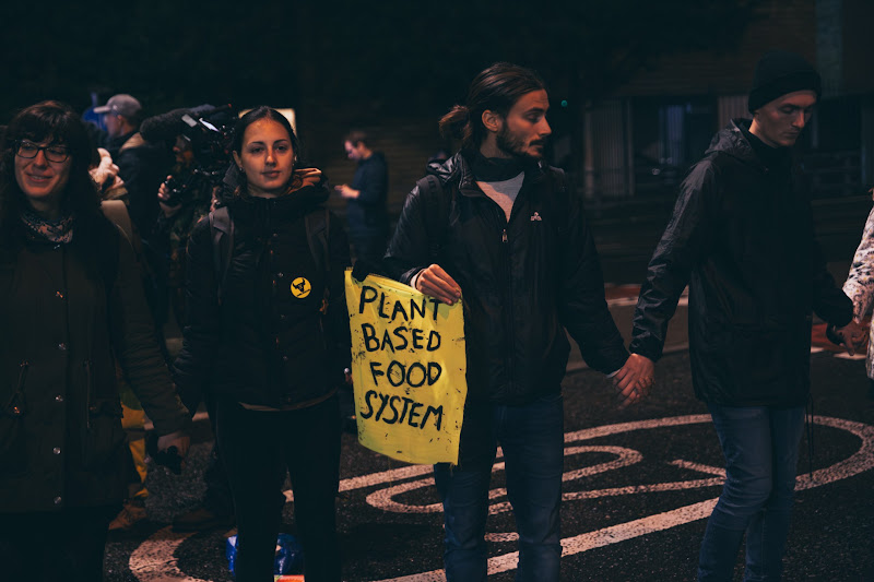 Actvists Hold ‘Plant Based Food System’ Sign At Fish Market Protest