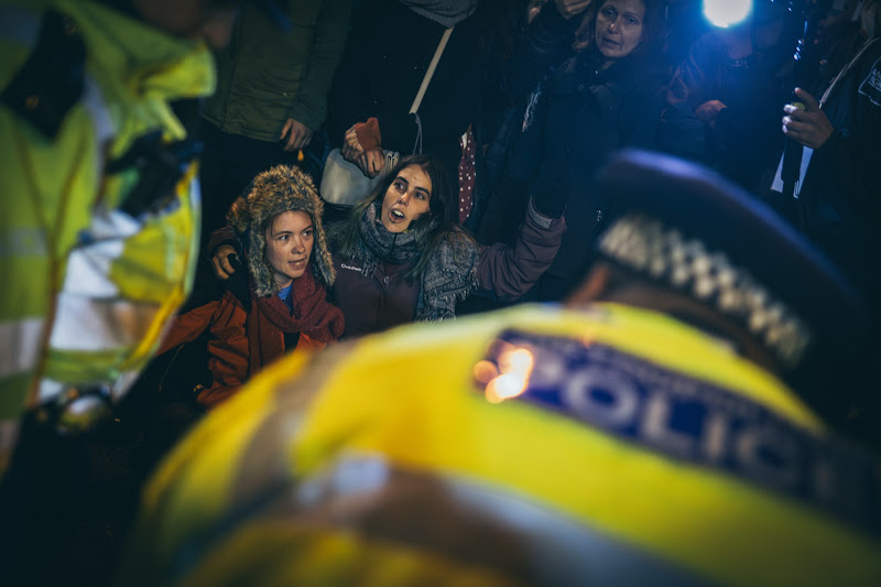 Activists Sing While Surrounded By Police At Fish Market Protest